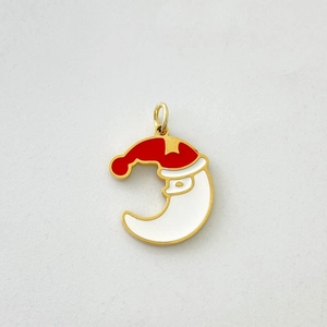 Detailed view of moon and Santa Claus pendant in gold metal with red and white enamel finish