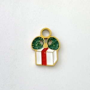 Detailed close-up of a Christmas gift box charm with red ribbon and green bow for DIY jewelry