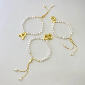 Adjustable pearl bracelet with vintage gold puff alphabet letters A, B, and C charms