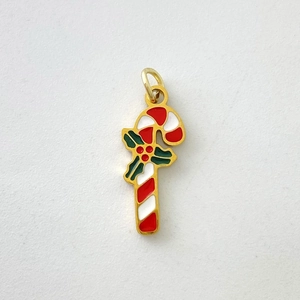 Detail of Christmas candy cane pendant with holly leaf design and festive enamel finish