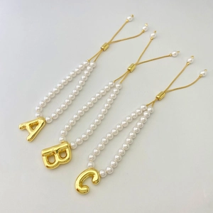 Adjustable pearl bracelet with gold puff letter charms A B and C in bubble style