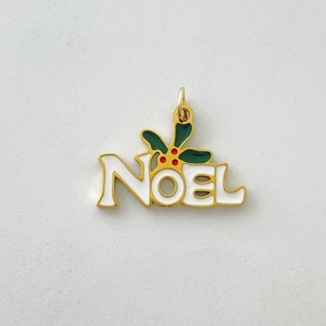 Macro view of NOEL letter pendant with enamel holly leaves and red berry details