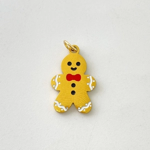 Detailed view of gingerbread man pendant with gold finish and colorful enamel detailing