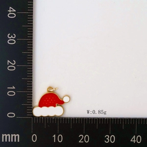 Detailed macro view of a 15mm Christmas hat pendant with red enamel and 0.85g weight