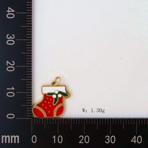 Detail showing red and green Christmas stocking pendant dimensions on a measuring scale
