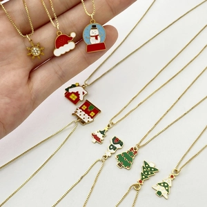 Golden stainless steel Christmas necklace set featuring snowflake and reindeer pendants