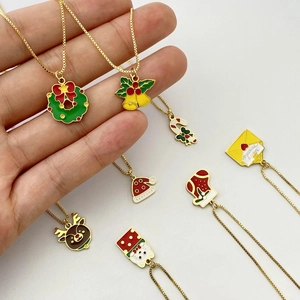 Golden Christmas necklaces featuring colorful pendants like reindeer, bells and trees