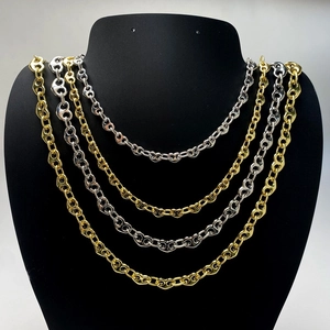 Detail of interlocking heart pig nose chains in gold and silver finish on a display