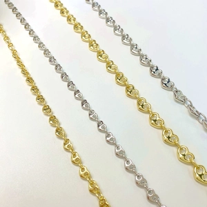 Detail of heart-shaped link chains in gold and silver finish for DIY jewelry