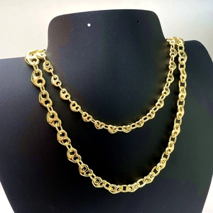 Golden heart-shaped geometric chain link necklace displayed on a black jewelry bust