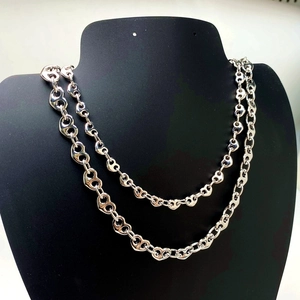 Silver coffee bean link necklace displayed on a jewelry mannequin neck stand