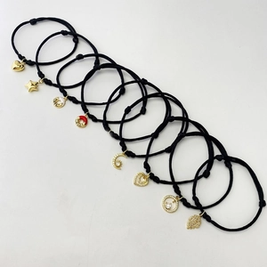 Set of eight adjustable black braided bracelets with gold-plated charms and zircons