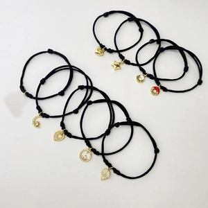 Adjustable black woven bracelets with gold plated heart moon leaf charms and cubic zirconia