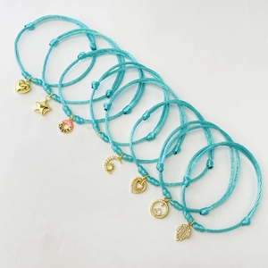 Set of 8 adjustable turquoise braided bracelets with gold-plated star and heart charms