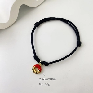 Detail of sweet engraved charm on black braided rope bracelet with precise dimensions