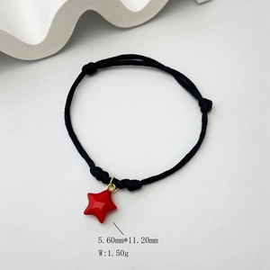 Detailed macro view of black braided rope bracelet with red star charm and dimensions