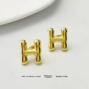 Macro detail of gold letter H stud earring with precise dimensions 16.50mm x 14mm