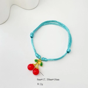 Macro detail of sky blue braided bracelet showing red cherry charms and 8x17.5mm dimensions