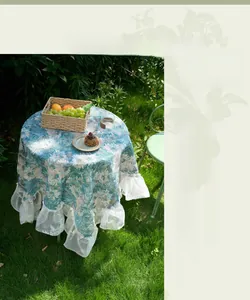 Detail of vintage floral jacquard tablecloth with elegant white lace ruffles at the edge