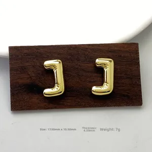 Detail view of gold letter J stud earrings showing unique fold design and precise 17.5mm size