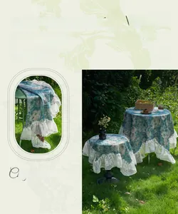 Close-up of European blue jacquard tablecloth with floral embroidery and white lace edges