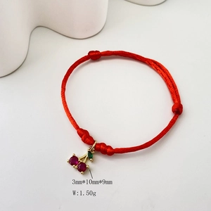 Detail view of handmade red string bracelet with cherry pendant and size dimensions