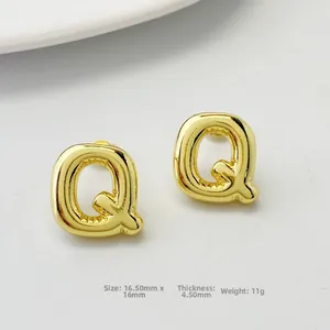 Detail view of gold letter Q stud earrings with a 3D balloon puff design for women