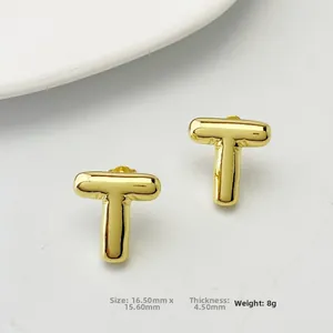 Detail view of 3D gold-tone letter T stud earrings with 16.5mm size measurements