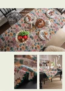 Macro detail of French vintage floral jacquard tablecloth with green wavy edges