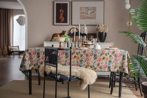Close-up of French vintage tablecloth with colorful floral jacquard and green stitching