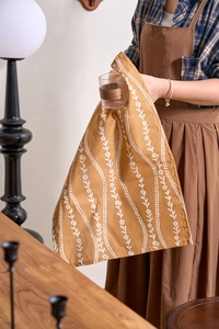 Detail view of mustard yellow floral cotton cloth used as an aesthetic photo prop