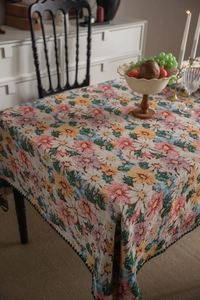 Detailed close-up of French vintage floral jacquard tablecloth with scalloped edges