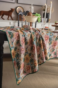 Detail of vintage floral jacquard tablecloth with elegant green scalloped crochet edges
