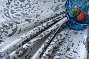 Close-up of grey and white mandala jacquard fabric with detailed floral texture pattern