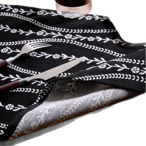 Nordic black floral print fabric napkin with white botanical pattern and place setting