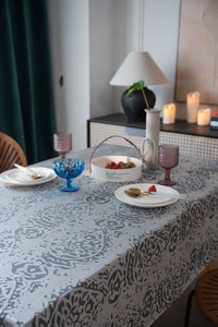 Close-up of gray floral jacquard tablecloth with elegant damask pattern and fabric texture