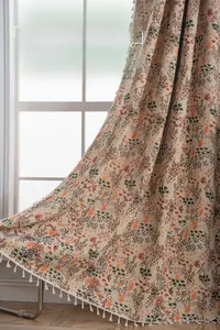 Detailed view of bohemian floral jacquard curtain with white tassels and relief texture