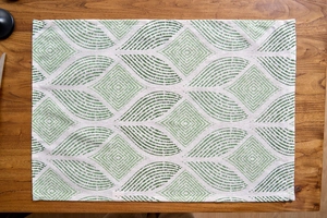 Detail of green leaf pattern on rectangular linen place mat with textured weave