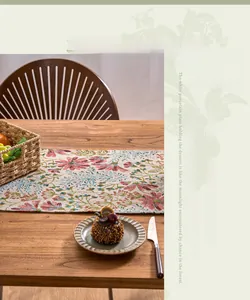 Macro shot of French pastoral jacquard table runner with pink floral patterns and tassels