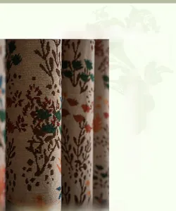 Detail of bohemian cotton curtain featuring vintage forest botanicals and elegant fringe tassels