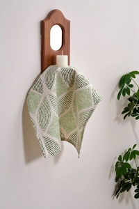 Detailed texture of green leaf print linen napkin for Nordic table decor and setting