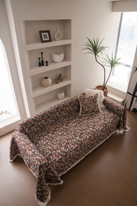 Detaillierte Textur von dicken floralen Sofaüberwürfen mit eleganten Quastenfransen