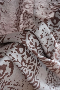 Close-up of brown floral jacquard curtain fabric with a refined silk-like texture