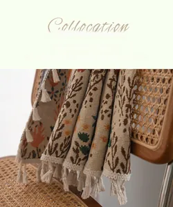 Detail of bohemian jacquard fabric with tassels on a rattan chair in soft lighting