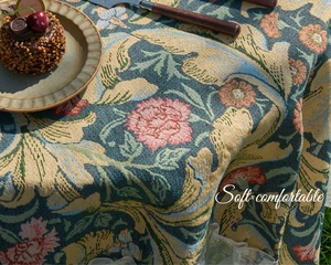 Macro detail of vintage jacquard tablecloth featuring floral patterns and white lace edges