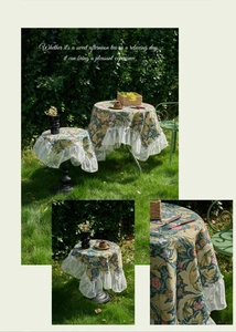 Close-up of vintage floral tablecloth with white lace edges and jacquard texture