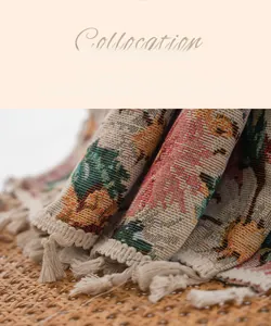 Close-up of bohemian floral jacquard fabric with elegant cream fringe and knit texture