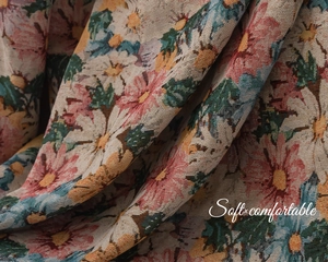Detail of colorful floral jacquard fabric showing intricate woven texture and soft drapes