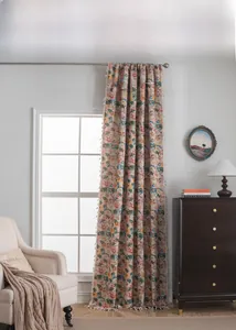 Detail of floral jacquard curtain with elegant white tassels and relief texture