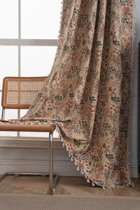Detail of bohemian floral curtain featuring vintage maple leaf jacquard and cream tassels